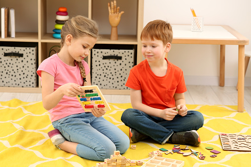 Playing With Math Children Playing With Different Math Game Kits On Floor In Room Study ...
