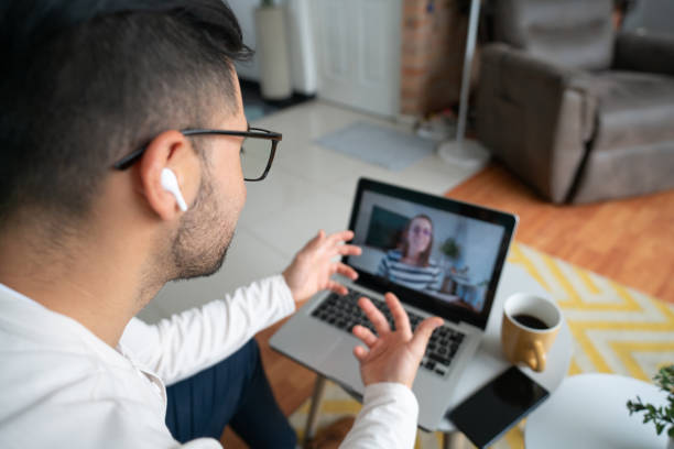 istock Man at home making a video call using his laptop 1804787651