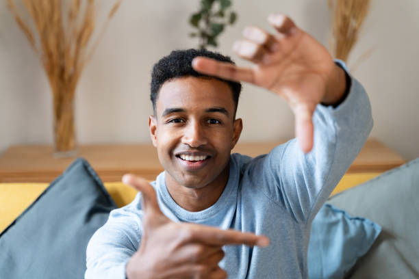 istock happy african american man gesturing frame with fingers at home 1804801287