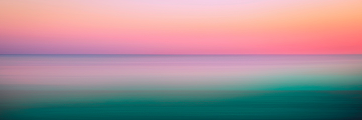 istock Romantic foggy motion blur sunset or sunrise landscape for soft warm-toned pastel seascape backgrounds 1804805477