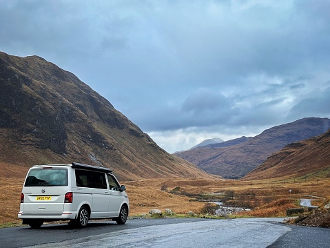 Glen Etive, Scotland, UK -  November 14th, 2023: An Ascot Grey  VW California Ocean parked along the side of the renowned Glen Etive road, famously featured as the iconic film location in Skyfall.