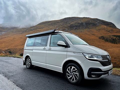 Glen Etive, Scotland, UK -  November 14th, 2023: An Ascot Grey  VW California Ocean parked along the side of the renowned Glen Etive road, famously featured as the iconic film location in Skyfall.