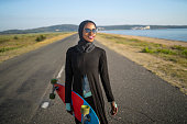 Portrait of a female Muslim skateboarder