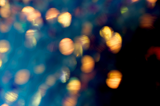 Dreamy golden bokeh and flare background, dark blue, yellow, black. Peaceful or serene backgrounds. Template banner. Wedding, Birthday, Valentines Day