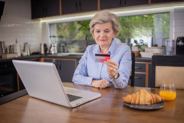 istock Happy senior customer enjoys shopping online 1804857350