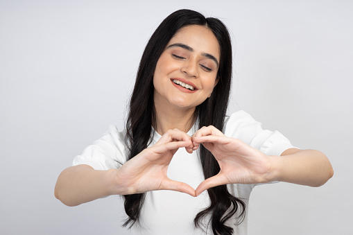 Portrait of young girl, copy space isolated over white background