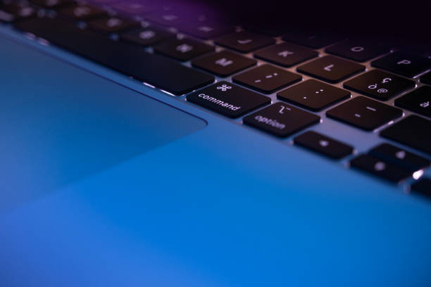 istock Close-up of laptop keyboard and touchpad in neon lighting 1804858607
