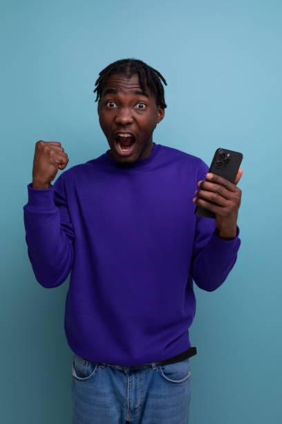 istock joyful american young man with dreadlocks won the competition 1804859535