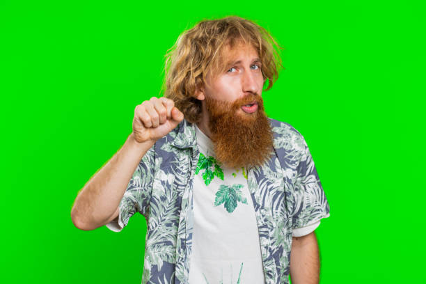 Knock-knock who is there. Confused excited young man knocking door gesture asking who is at home, feeling embarrassed, no idea, being clueless and uncertain. Guy isolated on chroma key background
