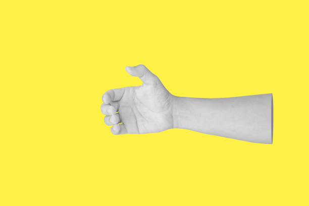 istock man hand gesture holding something like bottle isolated on yellow background 1804862185