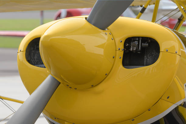 Front part of a light aircraft with a propeller. Screws, texture, surface, close-up
