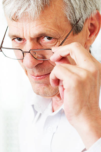 istock Very busy older man using a few phones 180486363