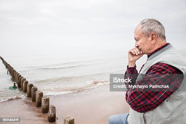 Thoughtful Elderly Man Standing On The Beach Stock Photo - Download Image Now - 60-69 Years, Active Seniors, Adult