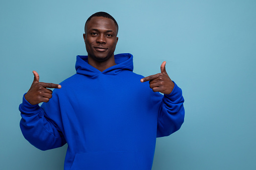 handsome ethnic young african man in stylish hoodie on studio background with copy space.