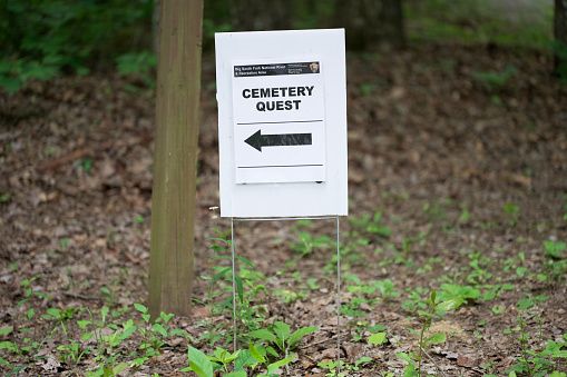 Stearns, Kentucky - May 28, 2023: Cemetery Quest temporary road sign in Big South Fork National River and Recreation Area near Stearns, Kentucky.