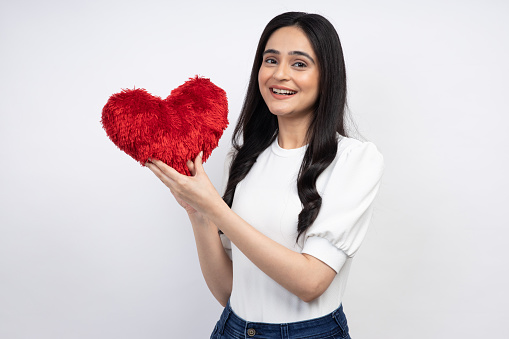 Indian woman presenting heart shape