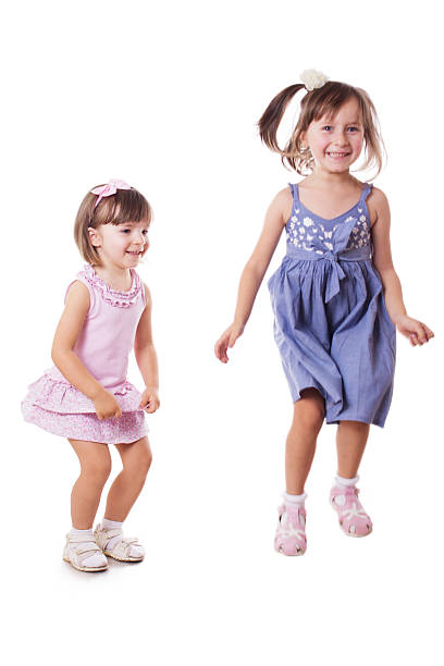 istock Two happy little sisters jumping 180491412