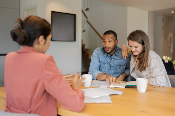 istock A financial advisor advises a multiracial couple at home 1804946266