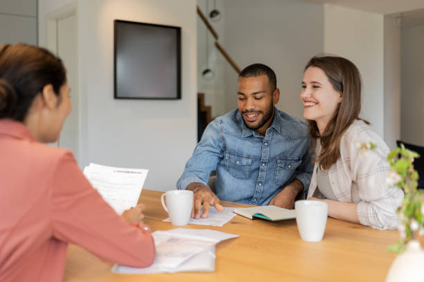 istock A financial advisor advises a multiracial couple at home 1804946290