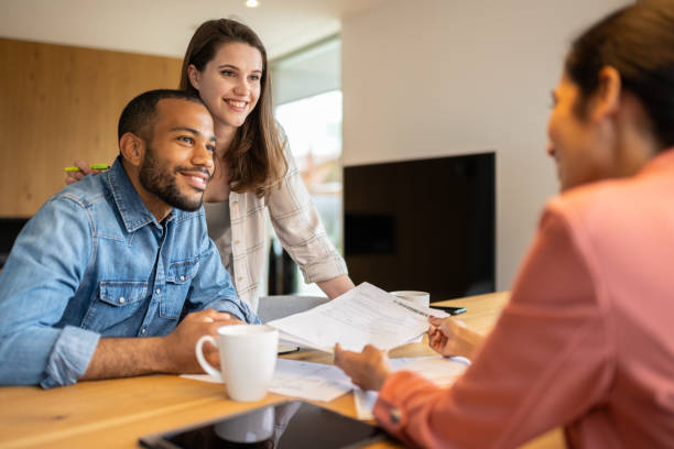 istock A financial advisor advises a multiracial couple at home 1804946558