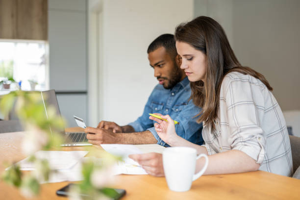 istock Multiracial couple paying bills online 1804946565