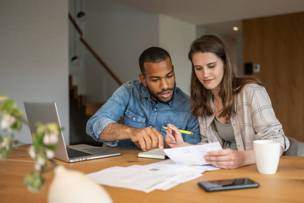 istock Multiracial couple paying bills online 1804946566