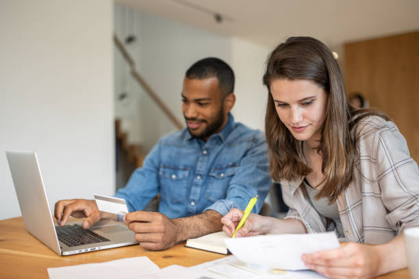 istock Multiracial couple paying bills online 1804946567