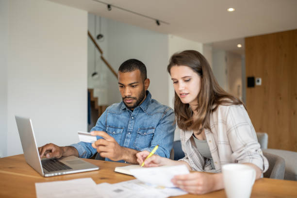 istock Multiracial couple paying bills online 1804946569