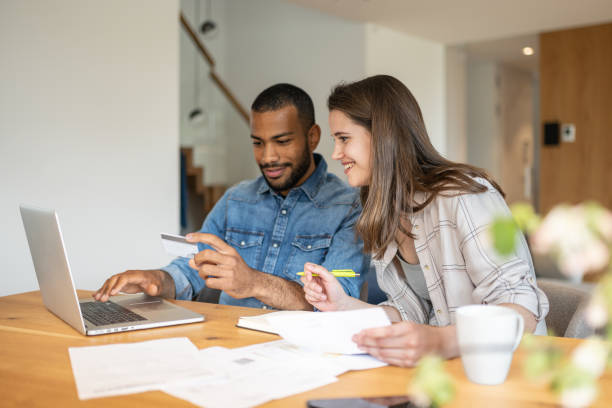 istock Multiracial couple paying bills online 1804946570