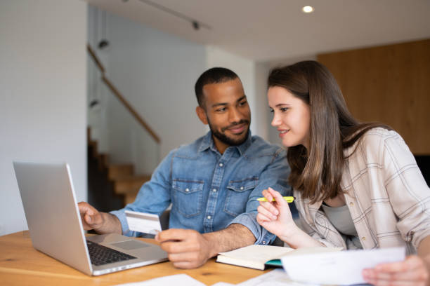 istock Multiracial couple paying bills online 1804946572