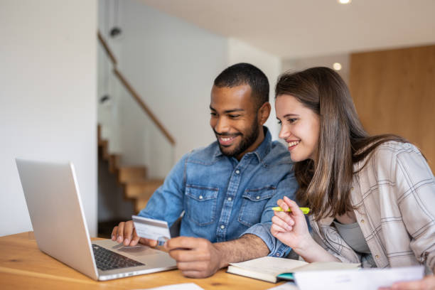 istock Multiracial couple paying bills online 1804946573