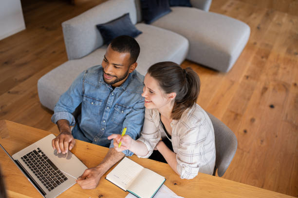 istock Multiracial couple paying bills online 1804946576