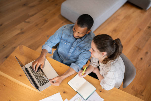 istock Multiracial couple paying bills online 1804946656