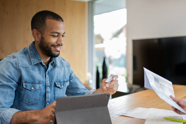 istock Multiracial couple paying bills online 1804947095