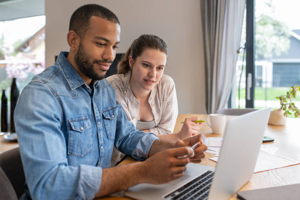 istock Multiracial couple paying bills online 1804947097