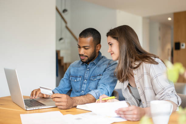 istock Multiracial couple paying bills online 1804947107