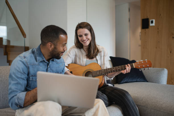 istock A man is playing the guitar at an online school. 1804947670