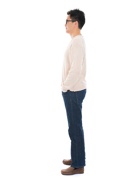 Side view full body casual Asian man Side view full body casual Asian man standing isolated on white background man standing profile stock pictures, royalty-free photos & images