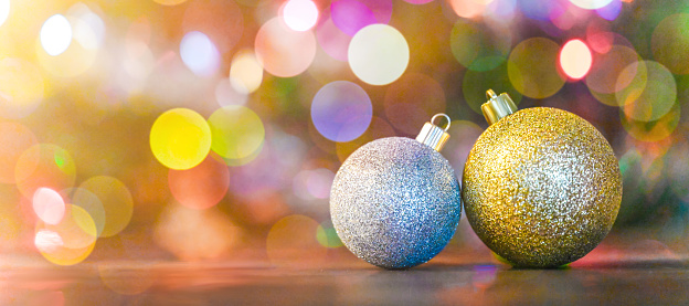 bright multi-colored decoration balls on the Christmas tree indoor closeup