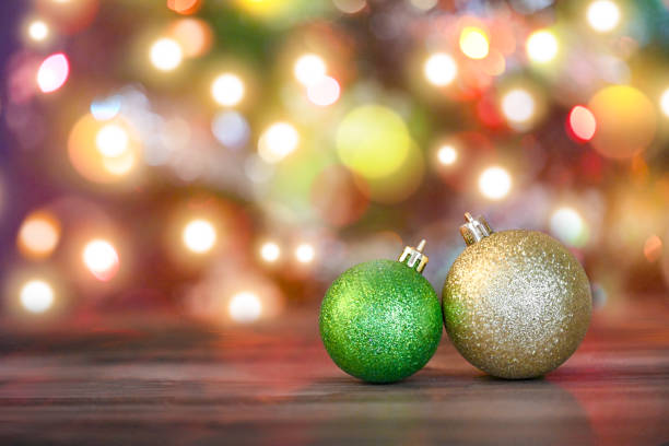 Christmas ornaments in the foreground with Christmas tree in the background. Christmas card, decoration.