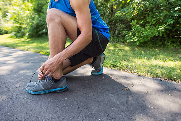 istock Man Tying His Sports Shoelace 180506217