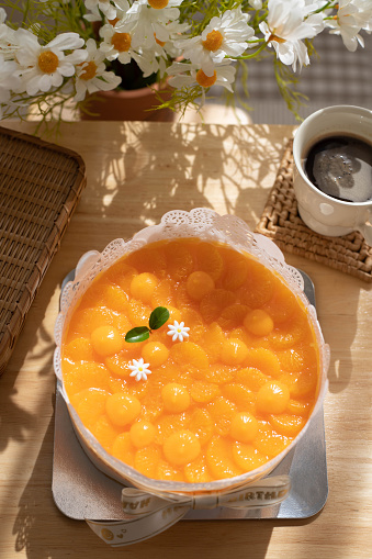 Orange cake with orange topping on the table