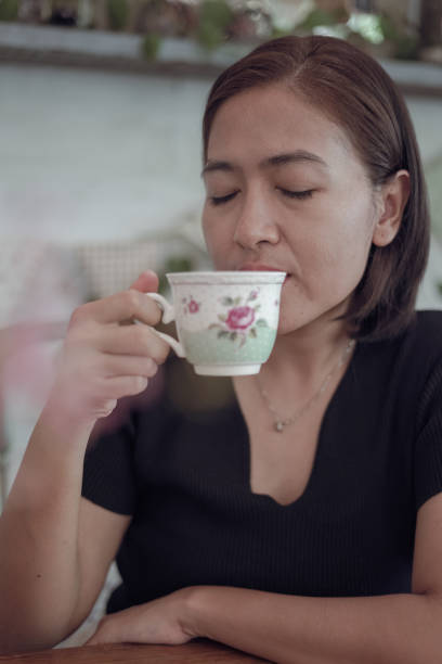 istock Woman drinking coffee in a cafe 1805100336