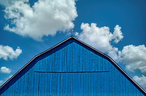 Blue Barn and  Blue Sky with Scattered Clouds