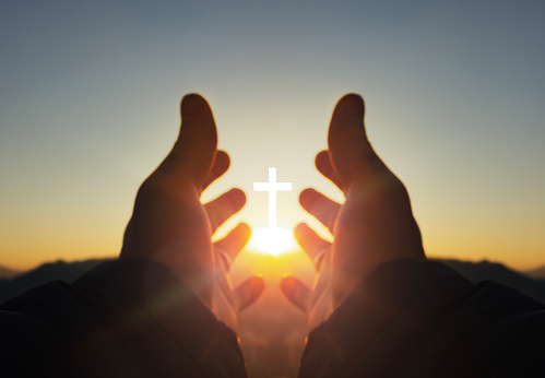 prayer concept, Human hands open palm up worship with sunrise on cross background