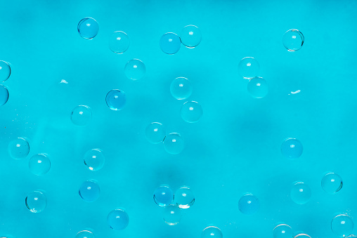 Abstract background with bubbles on a light blue, in closeup. Full frame