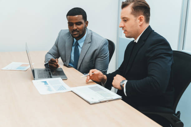 istock African male leader explain strategy while show solution to manager. Ornamented. 1805127713