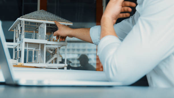 istock Skilled engineer compare house design between model and blueprint. Manipulator. 1805138126