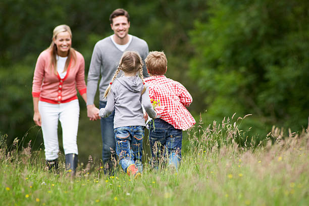 istock Family smiling and spending time in a park meadow 180515007