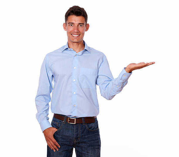 istock Smiling man in blue is holding his palm out. 180515046
